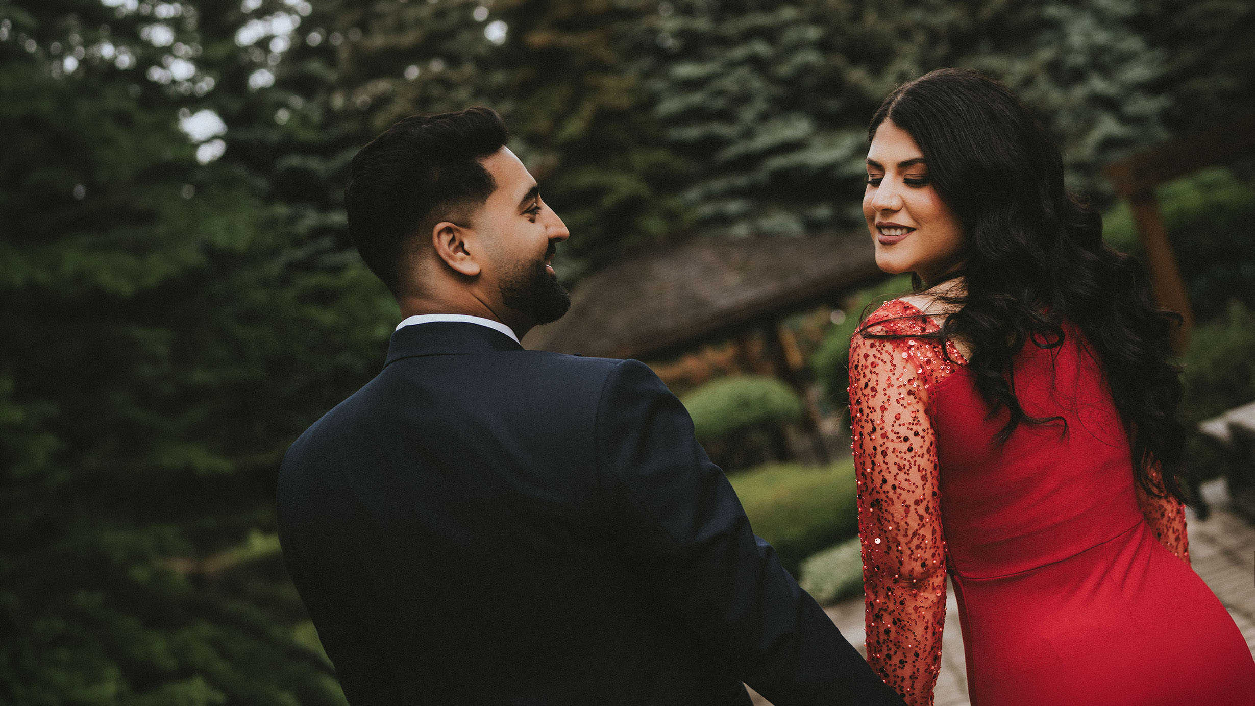 A newlywed couple share a quiet glance in a garden at golden hour — Toronto wedding photography by Harpreet Dhillon